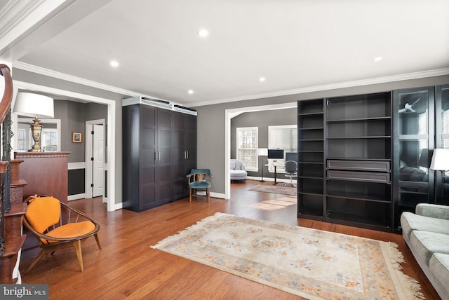 living room with hardwood / wood-style flooring and ornamental molding