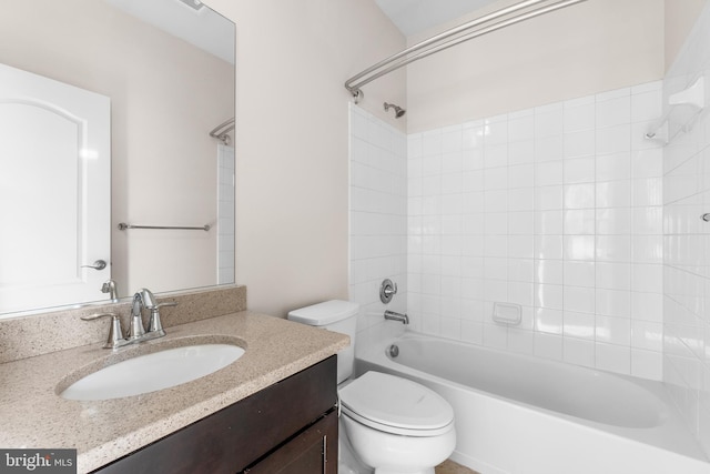 full bathroom with toilet, vanity, and tiled shower / bath combo