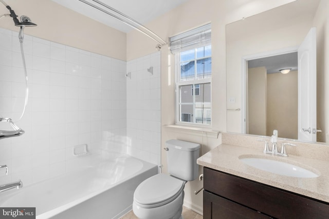 full bathroom featuring toilet, vanity, and tiled shower / bath