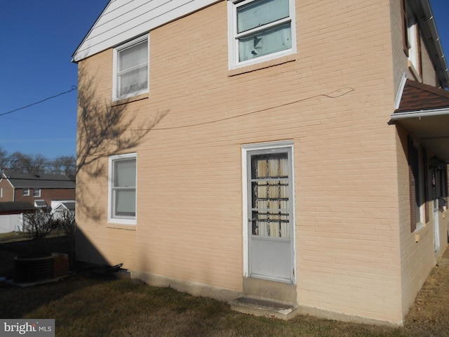 view of side of home with central air condition unit