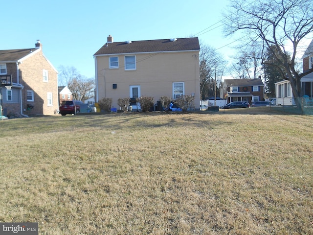 back of property featuring a lawn