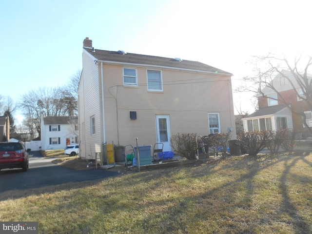 back of house with a lawn