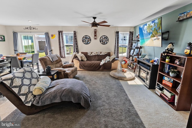 living room featuring ceiling fan and carpet