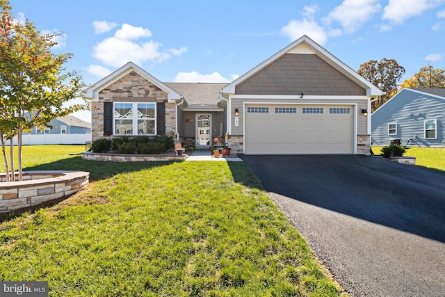 view of front of property with a garage and a front lawn