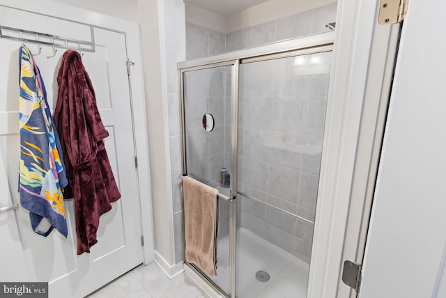 bathroom featuring tile patterned floors and a shower with door