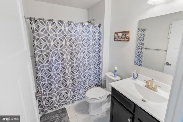 bathroom featuring tile patterned floors, vanity, and toilet