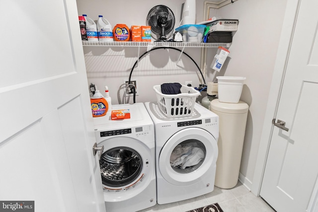 laundry room featuring washer and dryer and light tile patterned floors