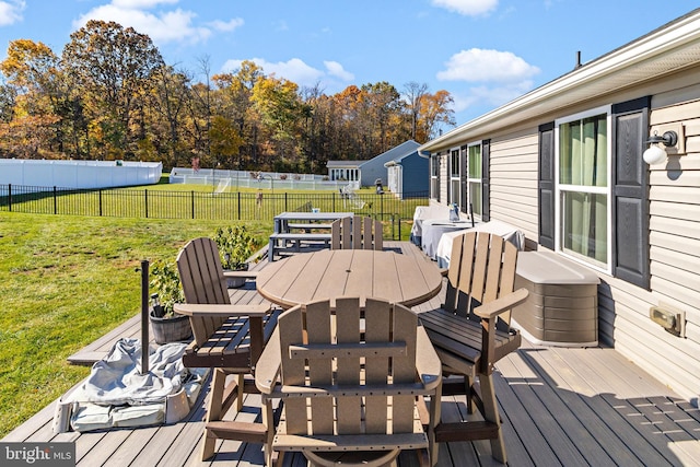 wooden deck featuring a yard