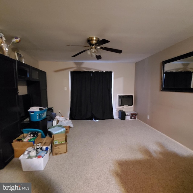 interior space featuring ceiling fan and carpet floors