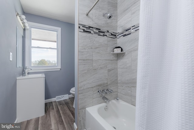 full bathroom featuring hardwood / wood-style floors, sink, toilet, and shower / bath combination with curtain