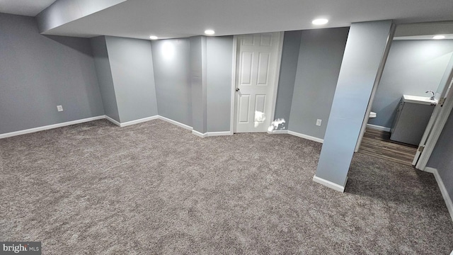 basement with dark colored carpet