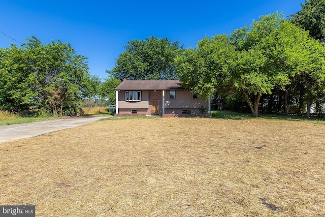 raised ranch featuring a front lawn