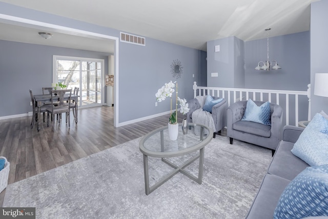 living room with a chandelier and hardwood / wood-style flooring