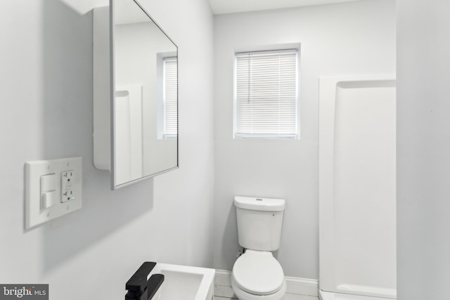 bathroom with tile patterned flooring and toilet