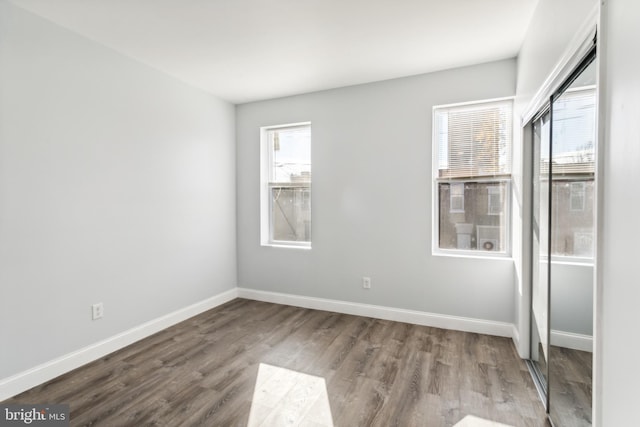 empty room with hardwood / wood-style flooring