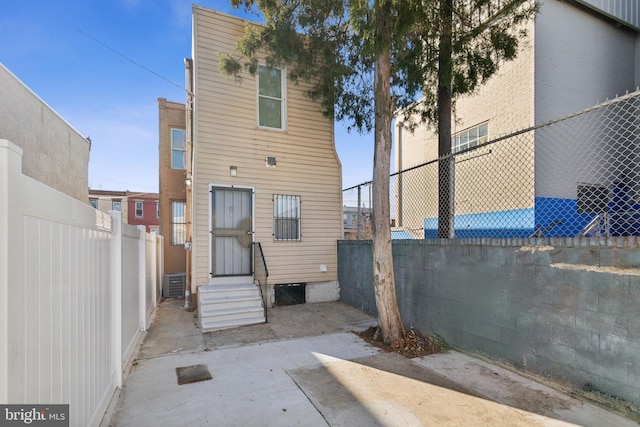 rear view of property featuring central AC unit