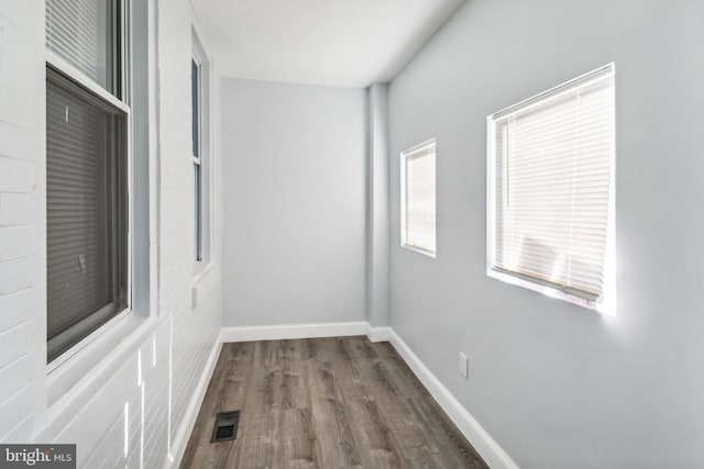 hallway with dark hardwood / wood-style floors