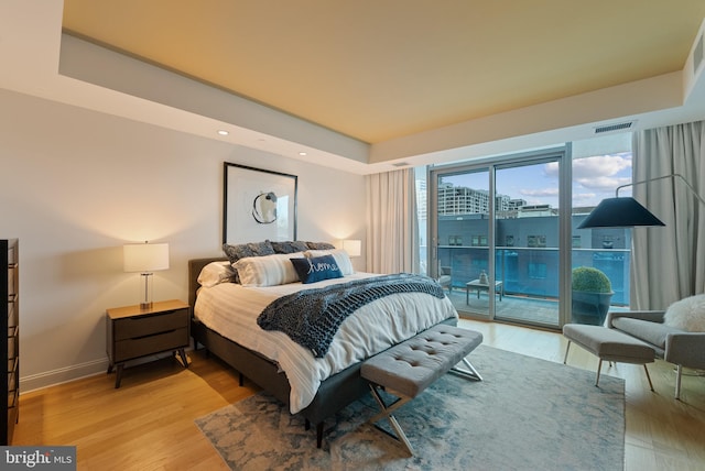 bedroom with light hardwood / wood-style floors and access to outside