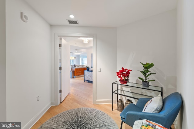 corridor with light hardwood / wood-style flooring