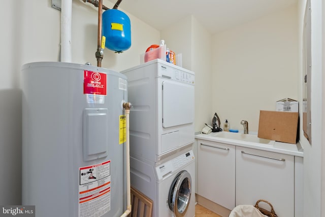 clothes washing area featuring water heater, sink, and stacked washer / drying machine