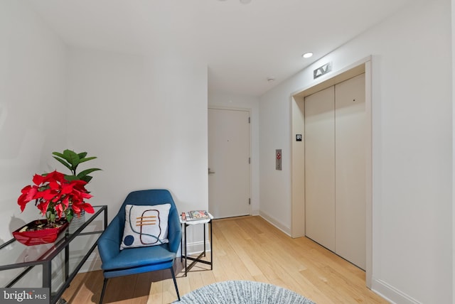 hallway featuring hardwood / wood-style flooring and elevator