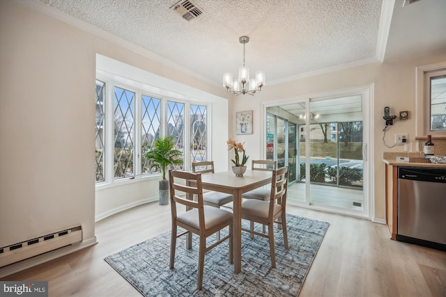 dining room featuring light wood finished floors, a chandelier, baseboard heating, and crown molding