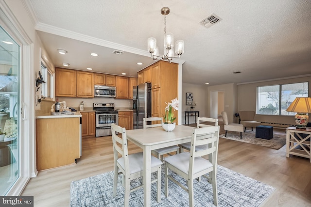 dining space with a chandelier, a textured ceiling, visible vents, and light wood-style floors