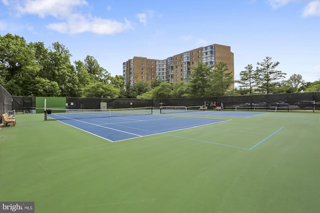 view of tennis court featuring fence