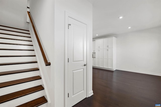 staircase with hardwood / wood-style flooring