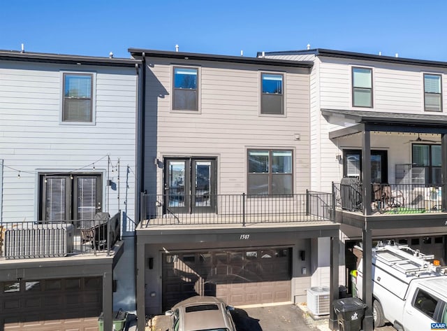 back of house featuring a garage and central air condition unit