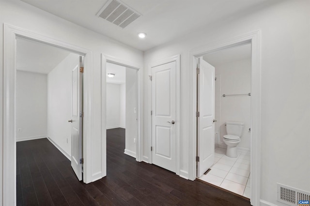 corridor featuring dark hardwood / wood-style floors