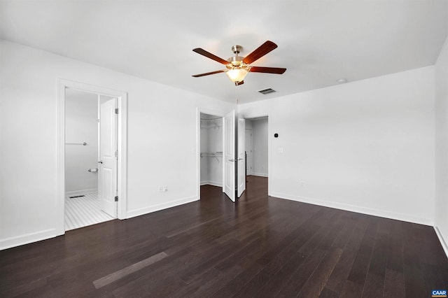 empty room featuring dark hardwood / wood-style flooring and ceiling fan