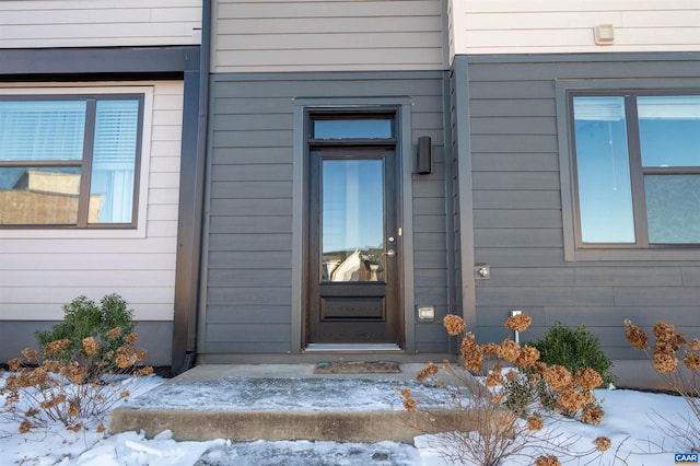 view of snow covered property entrance