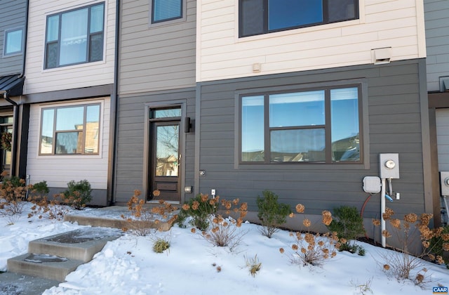 view of snow covered property entrance