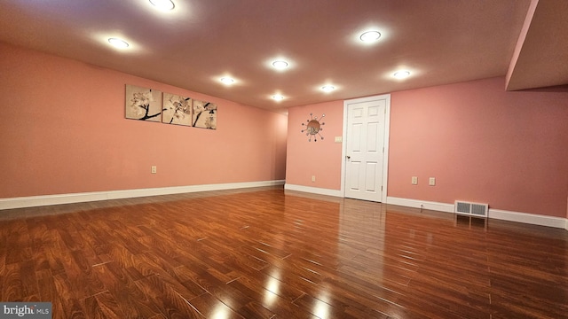 unfurnished room with dark wood-type flooring