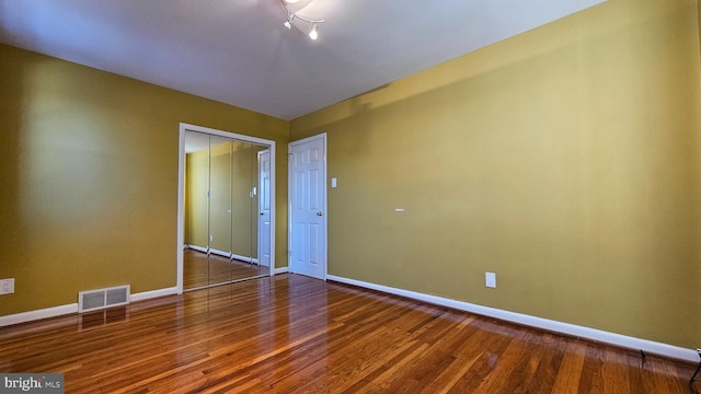 spare room featuring hardwood / wood-style floors