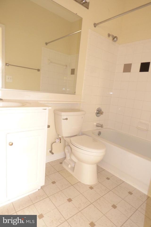 full bathroom featuring tiled shower / bath, vanity, and toilet