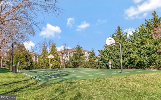 view of basketball court featuring a yard