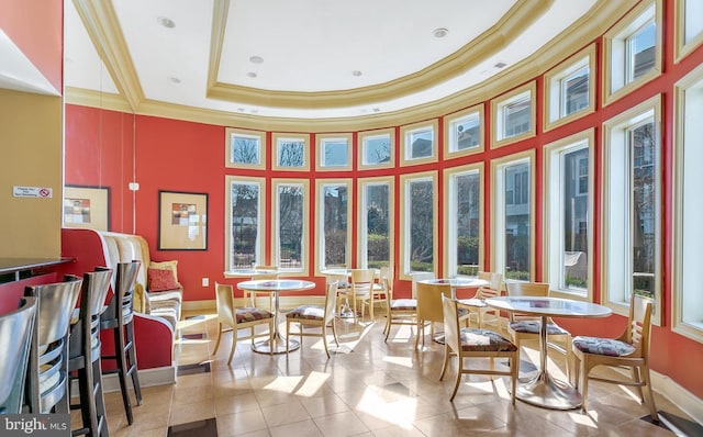 sunroom / solarium with a raised ceiling