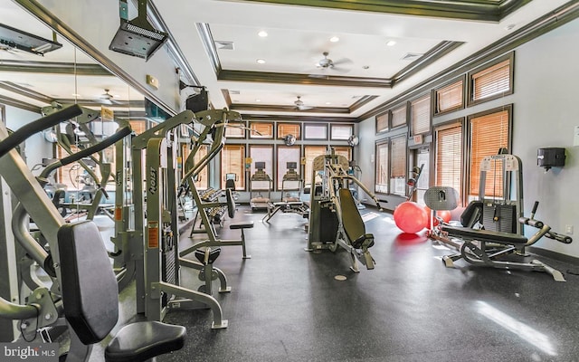 workout area with crown molding, a raised ceiling, and ceiling fan