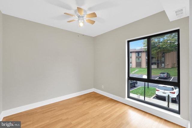 unfurnished room featuring hardwood / wood-style floors and ceiling fan