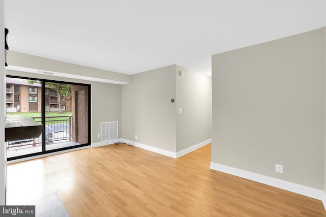 unfurnished room with light wood-type flooring