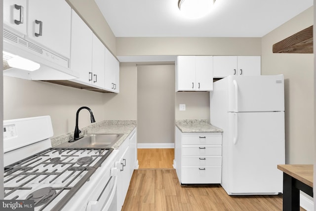 kitchen featuring white cabinets, light wood-type flooring, white appliances, and sink