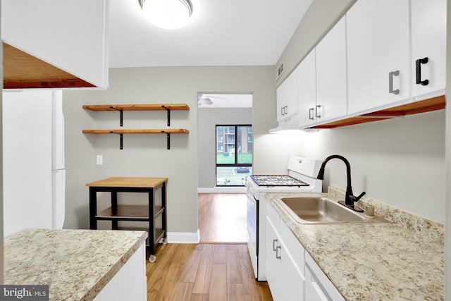 kitchen with white range with electric cooktop, sink, white cabinets, and light hardwood / wood-style floors