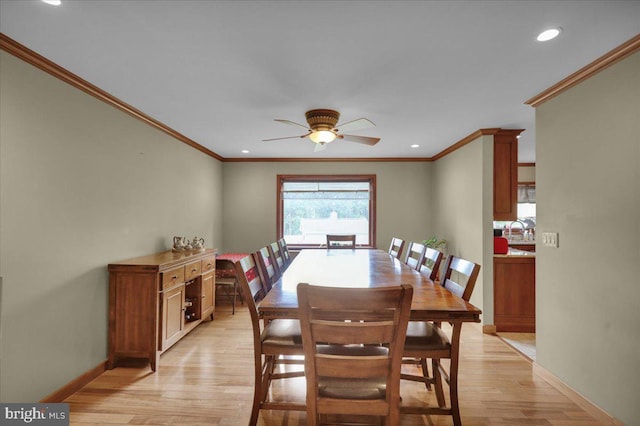 dining room featuring ceiling fan, ornamental molding, and light wood-type flooring