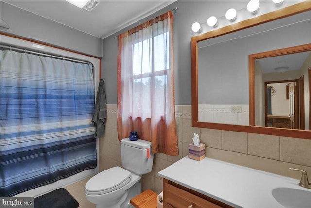 bathroom featuring tile patterned flooring, vanity, tile walls, and toilet