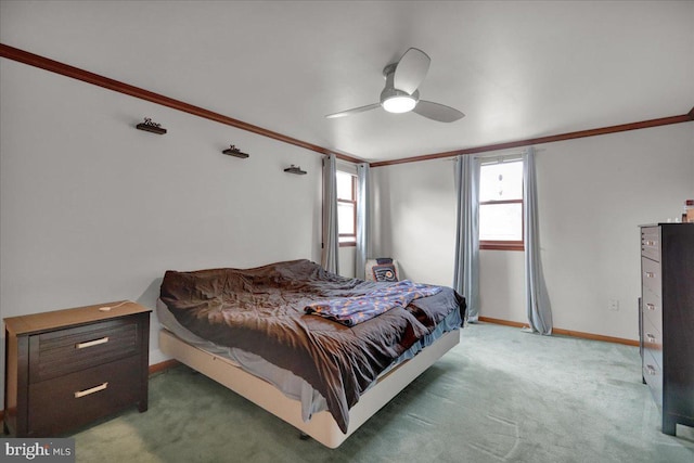 bedroom featuring ceiling fan, crown molding, and dark carpet