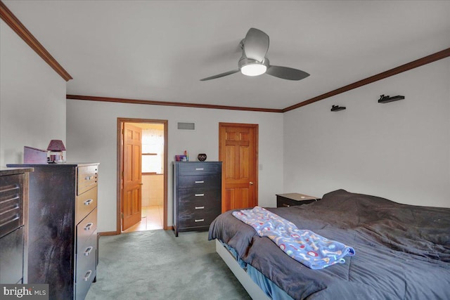 carpeted bedroom featuring ensuite bath, ceiling fan, and crown molding