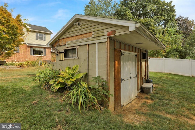 view of outdoor structure featuring a lawn