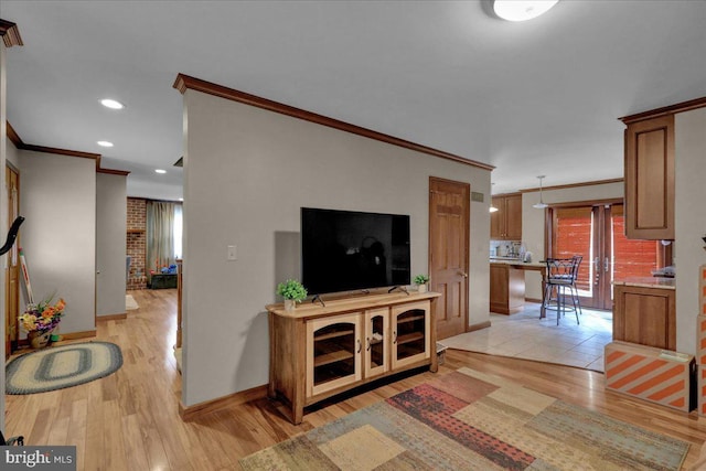 living room with light hardwood / wood-style flooring and ornamental molding